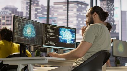 Developer at monitors with an artificial intelligence visualisation – AI in business